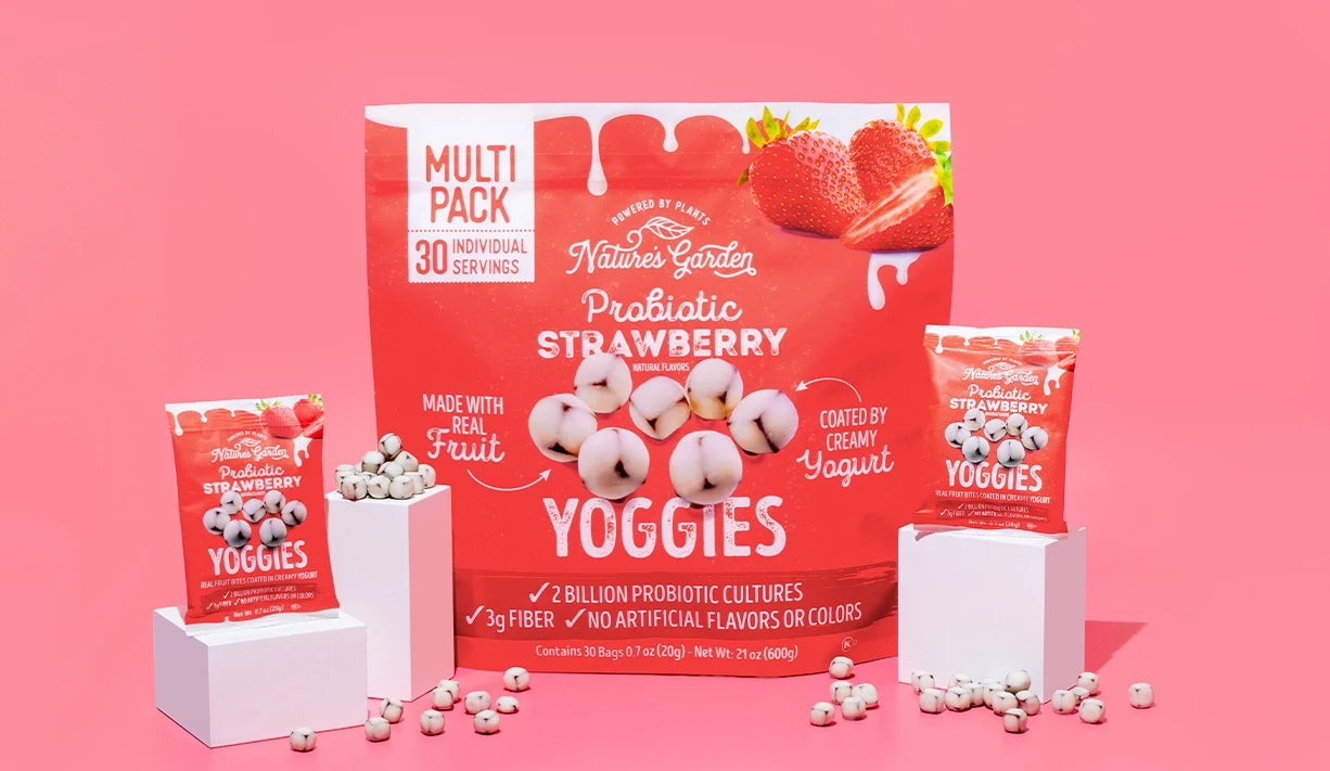 Nature’s Garden Probiotic Strawberry Yoggies with yogurt-coated real fruit bites, displayed in 30-count snack packs on a pink background.