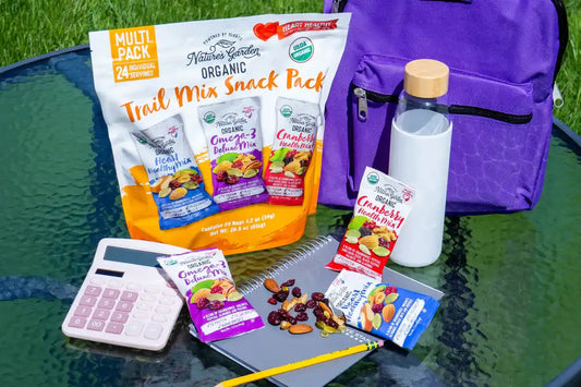 Nature’s Garden Organic Trail Mix Snack Pack with school supplies and backpack—perfect healthy snack for kids’ lunch boxes or study time