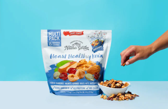 Nature’s Garden Heart Healthy Mix multi-pack with nuts and dried fruit in USA, shown with serving bowl and hand reaching in.
