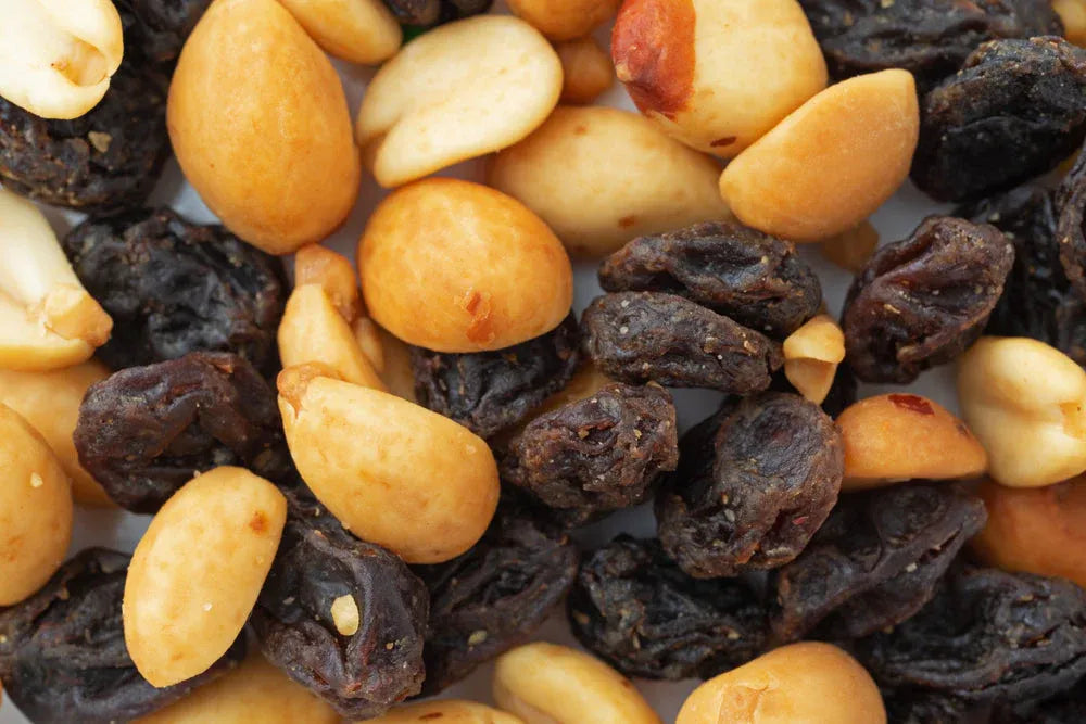 Close-up of classic GORP mix with roasted peanuts and raisins, a traditional hiking snack for energy and trail nutrition.