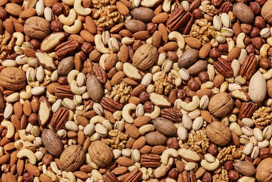 Assorted nuts including almonds, walnuts, cashews and pistachios for post-workout muscle recovery snacks