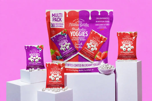 Nature’s Garden Probiotic Yoggies Snack Packs with strawberry and mixed berry yogurt-covered fruit bites displayed against a pink background.