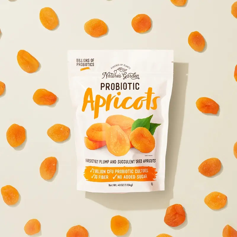 Nature’s Garden Probiotic Apricots pouch with dried apricots scattered on beige background.